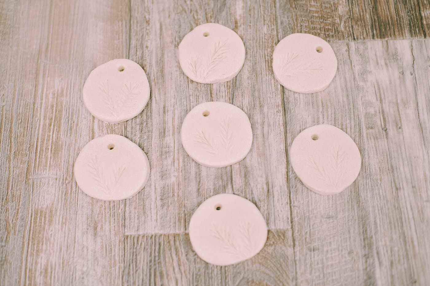 Salt dough ornaments with pine needles pressed into them.