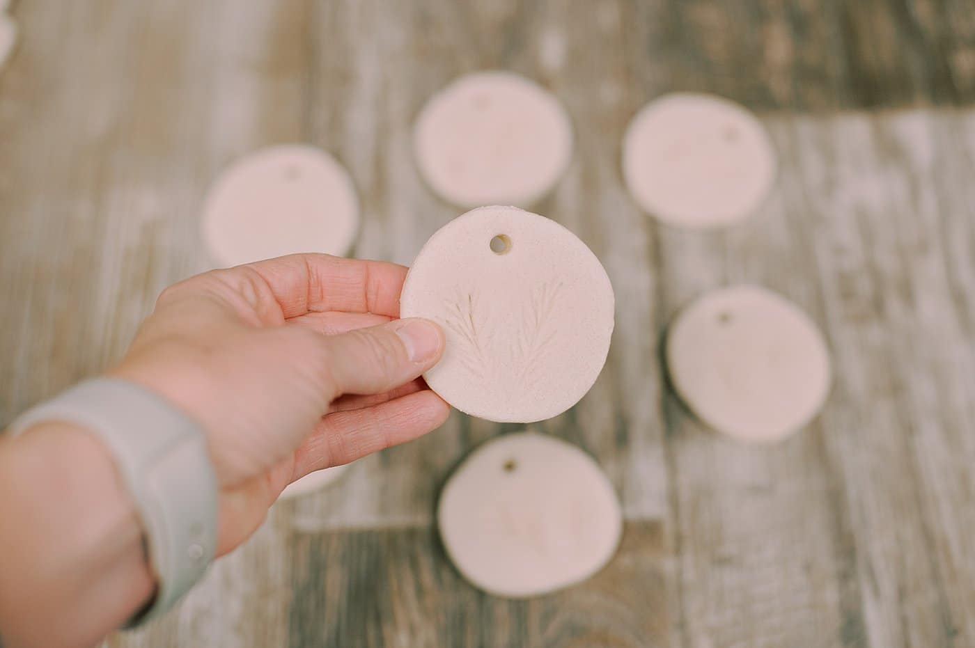 Salt dough ornaments with pine needles pressed into them.