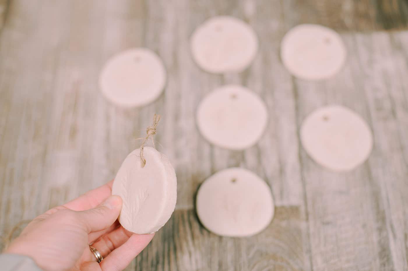 Salt dough ornaments with pine needles pressed into them.