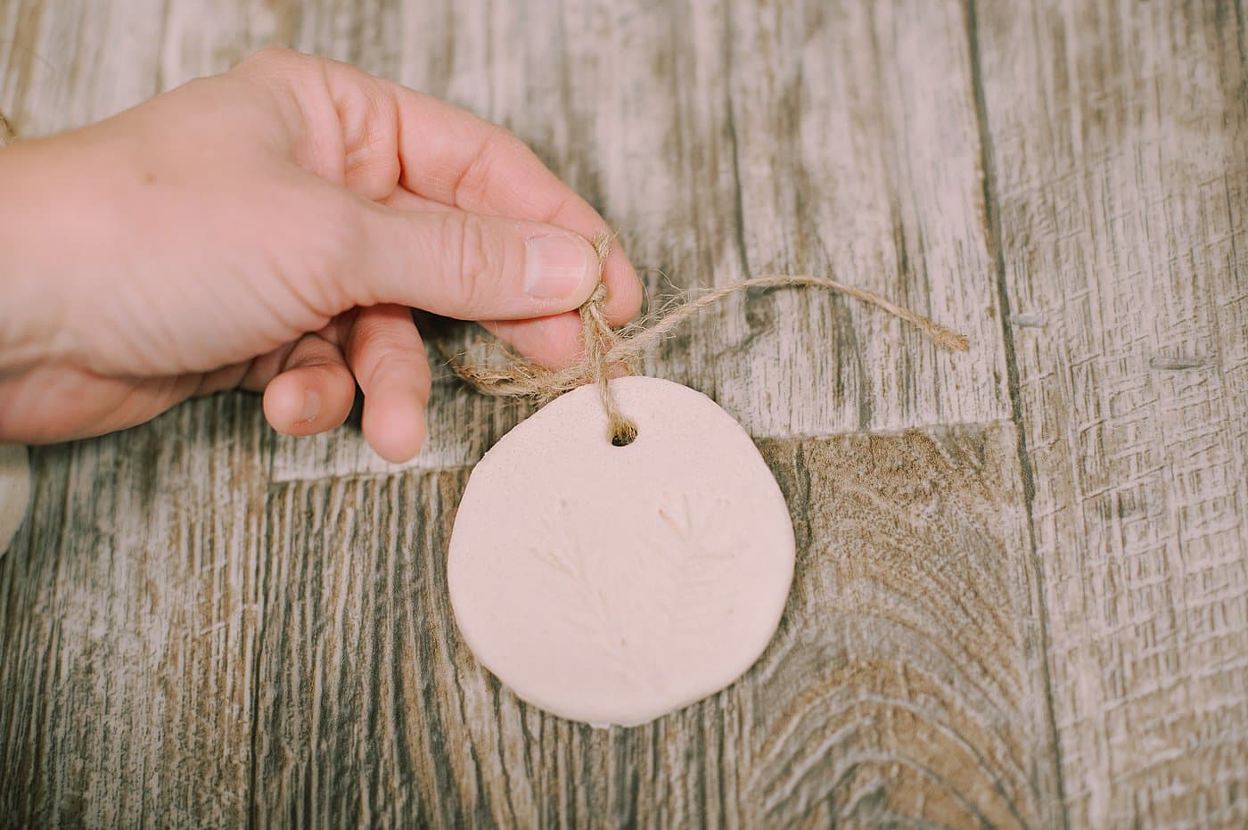 Tie small twine strings to the salt dough ornaments so you can add them to a longer twine string to hang as a garland.