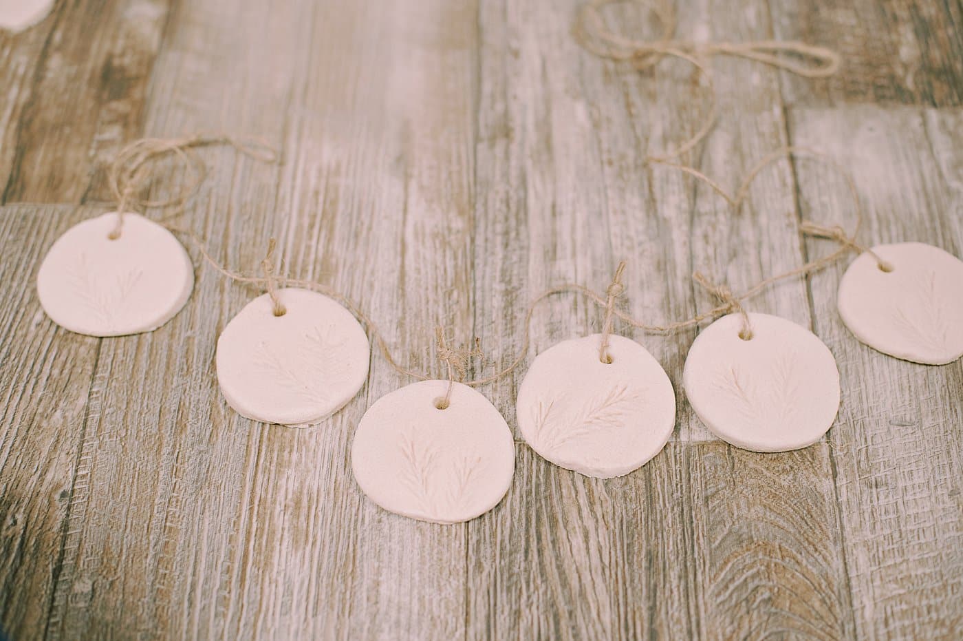 Tie small twine strings to the salt dough ornaments so you can add them to a longer twine string to hang as a garland.