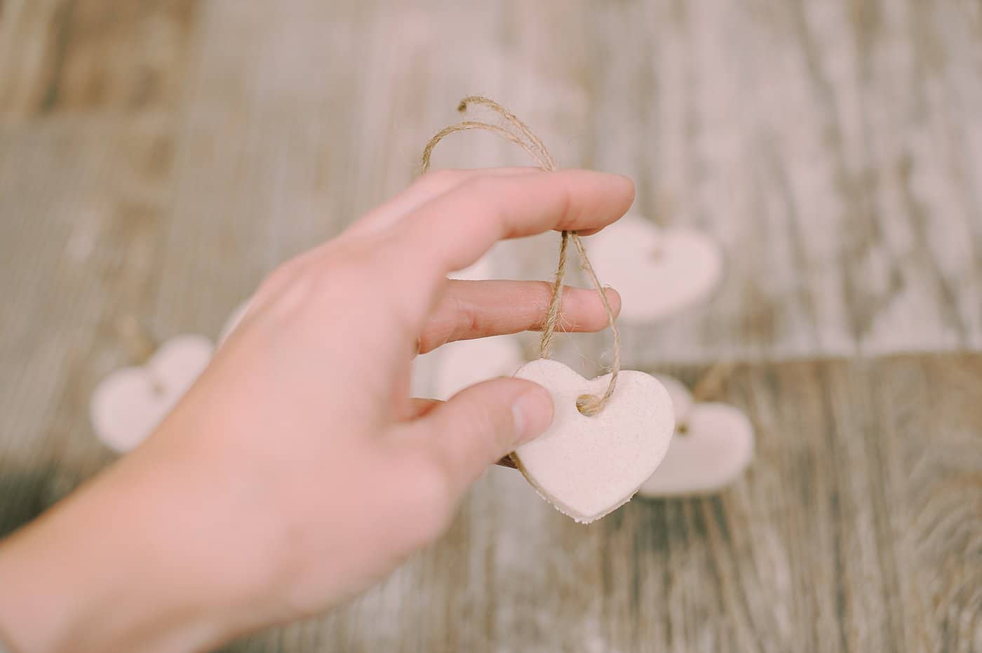 Tie small twine strings to the salt dough ornaments so you can add them to a longer twine string to hang as a garland.