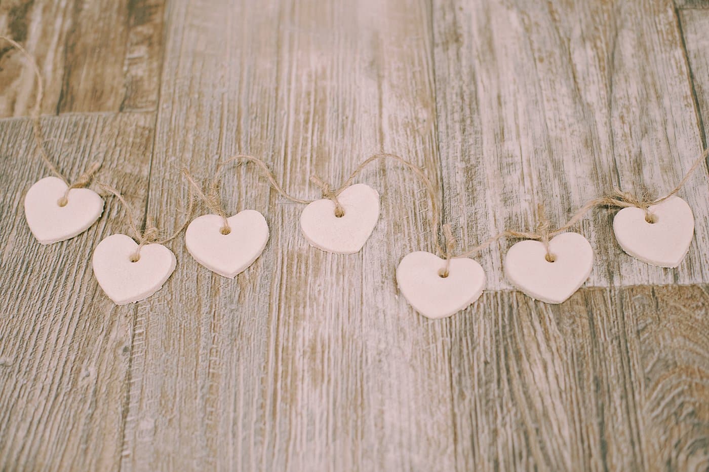 Tie small twine strings to the salt dough ornaments so you can add them to a longer twine string to hang as a garland.