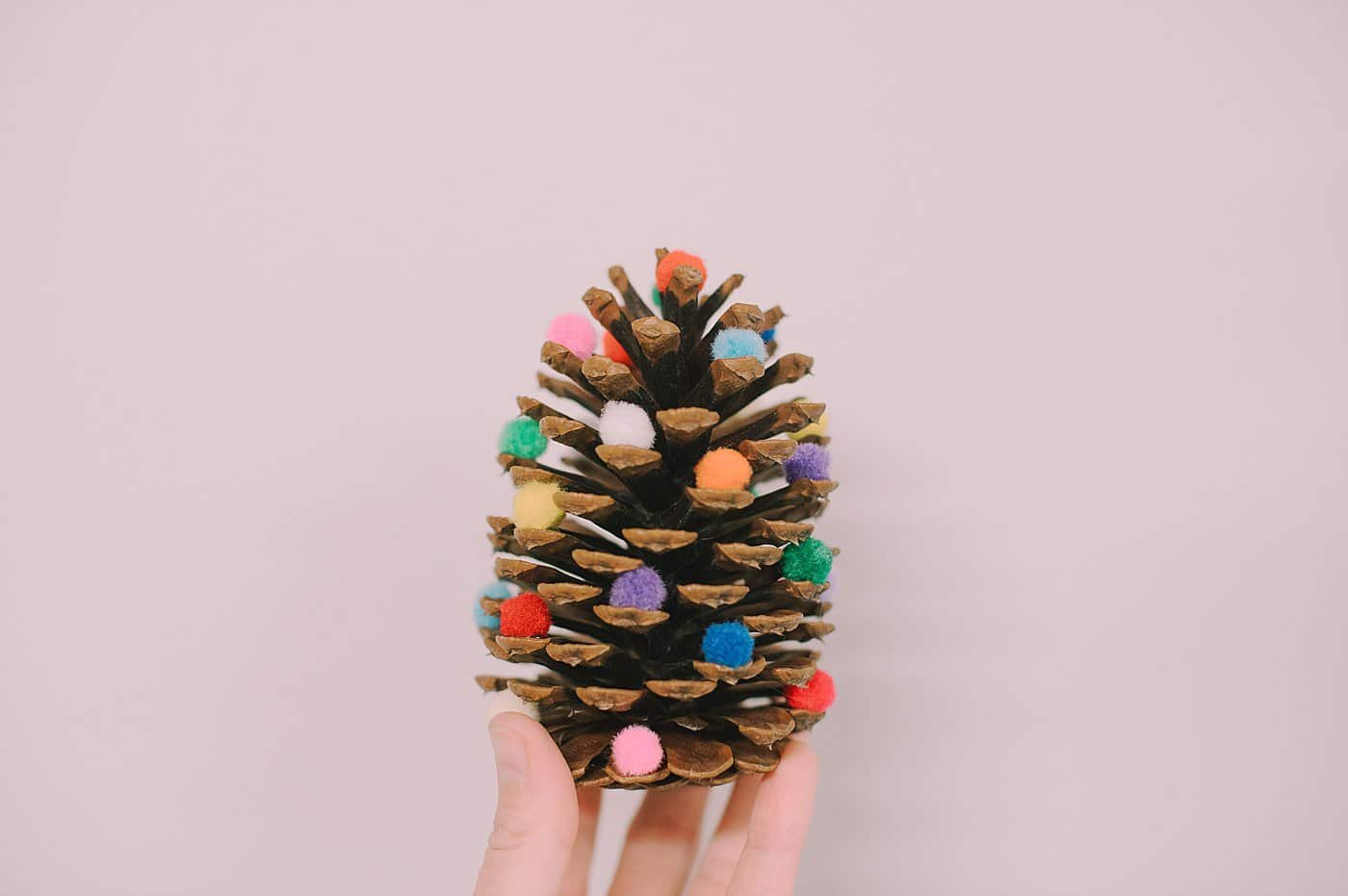 DIY Pinecone Christmas Trees with poms on it.