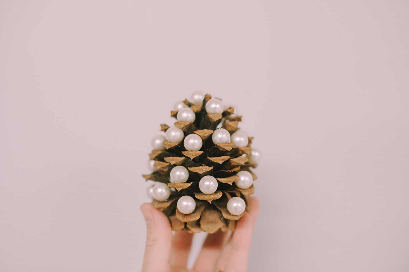 How to make a DIY pine cone Christmas tree with pearls on the ends.