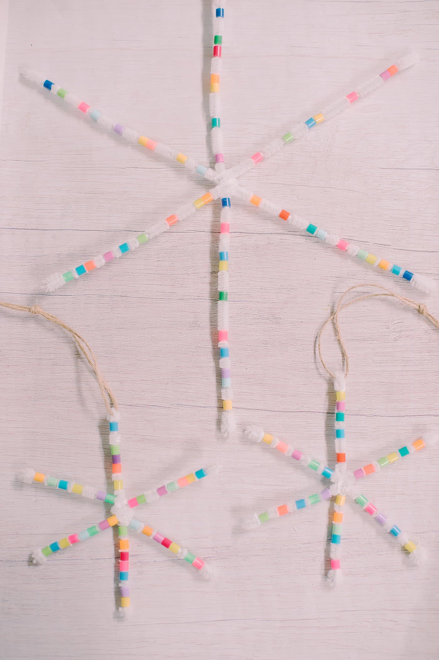 How to make perler bead pipe cleaner snowflake ornaments using white pipe cleaners and colorful perler beads.