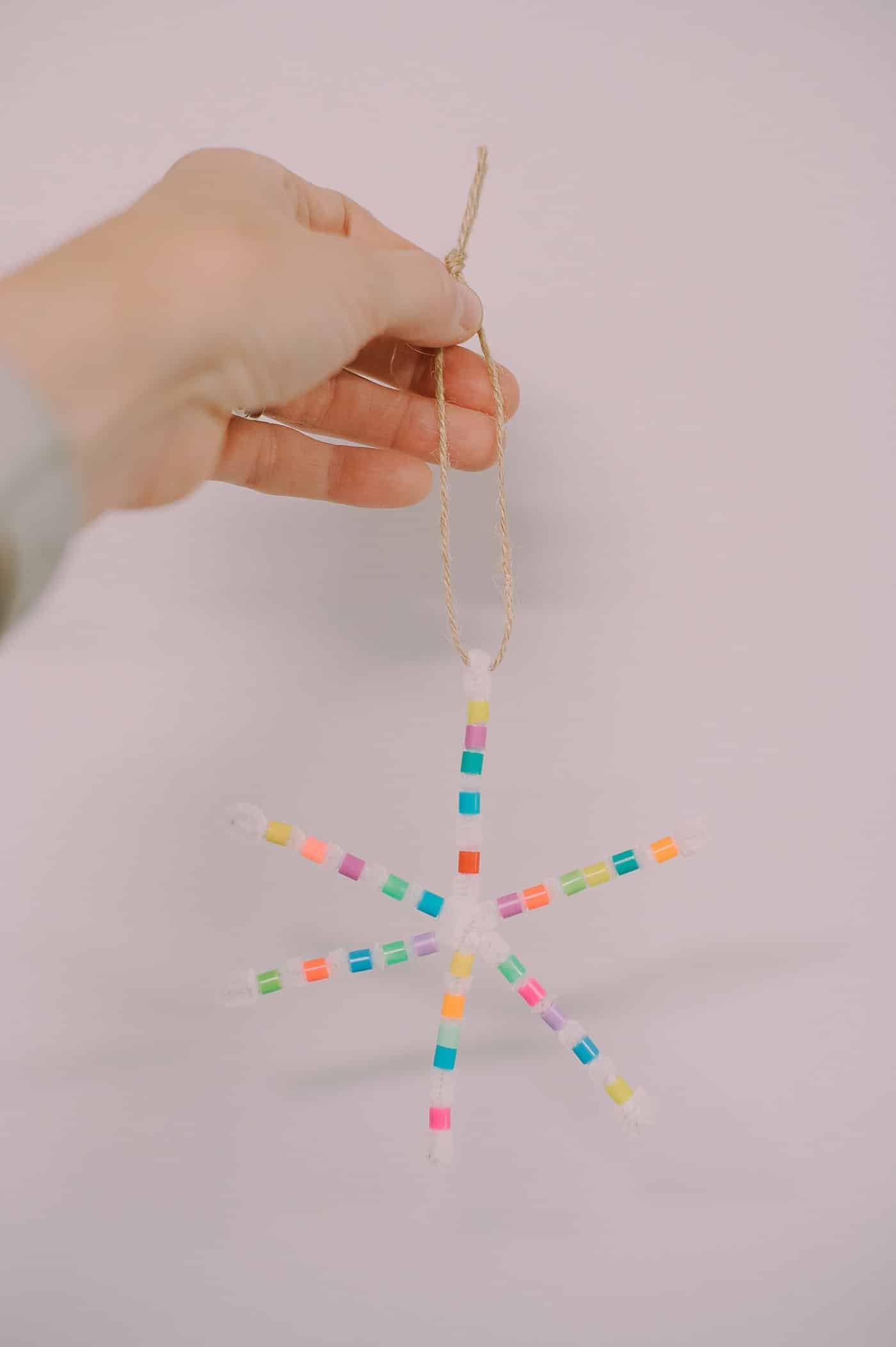 How to make perler bead pipe cleaner snowflake ornaments using white pipe cleaners and colorful perler beads.
