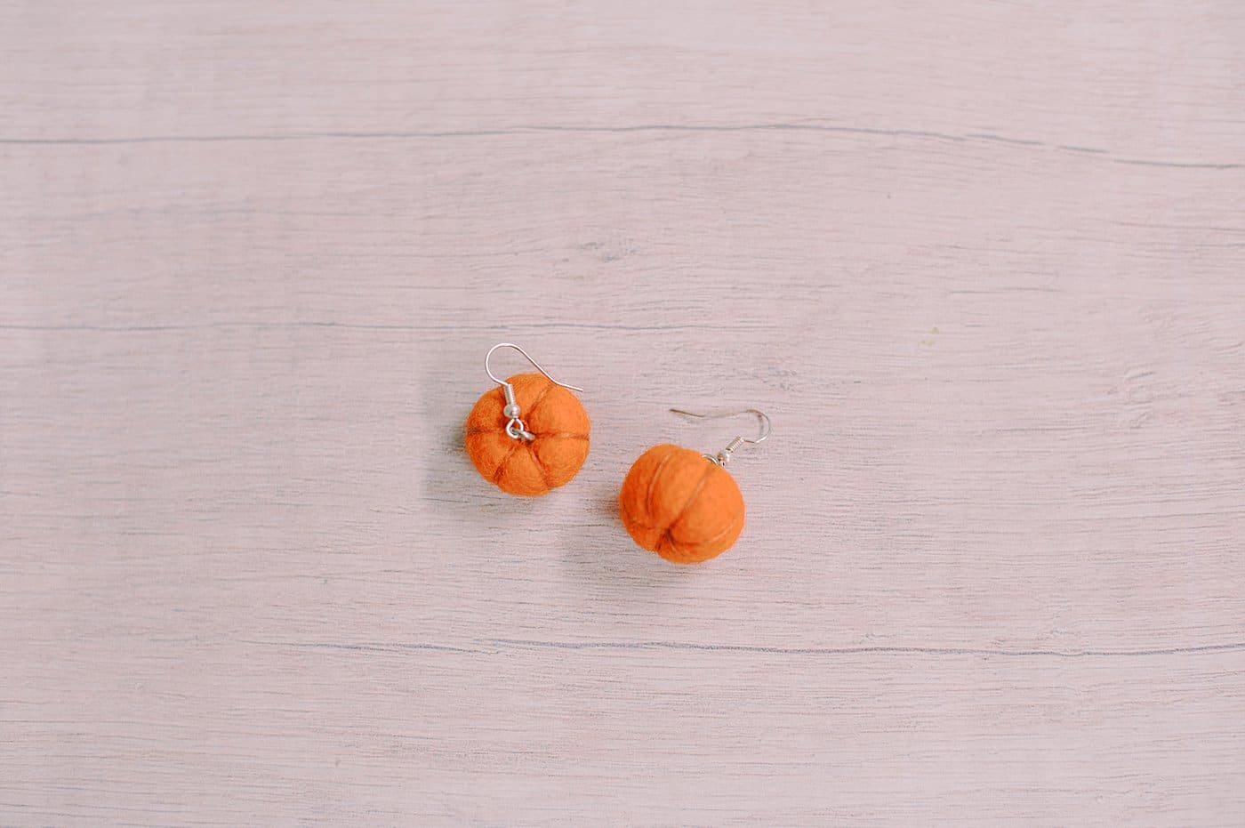 Felt ball pumpkin earrings.