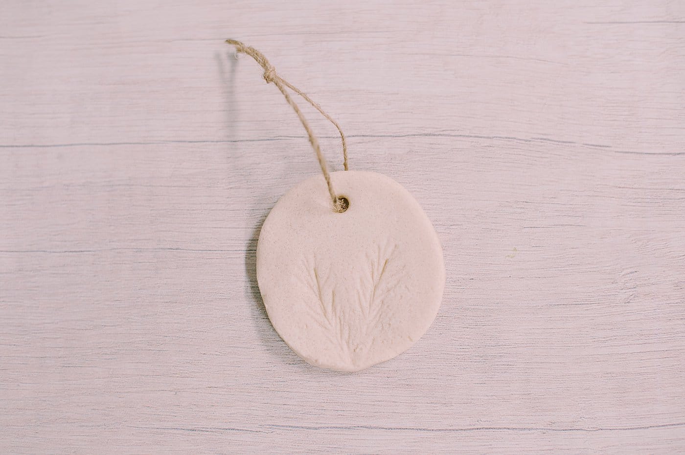 DIY salt dough ornaments with pine needles pressed into them for a pine design embellishment.