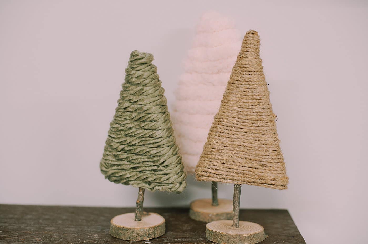 yarn trees made out of cardboard wrapped with different kinds of yarn or twine