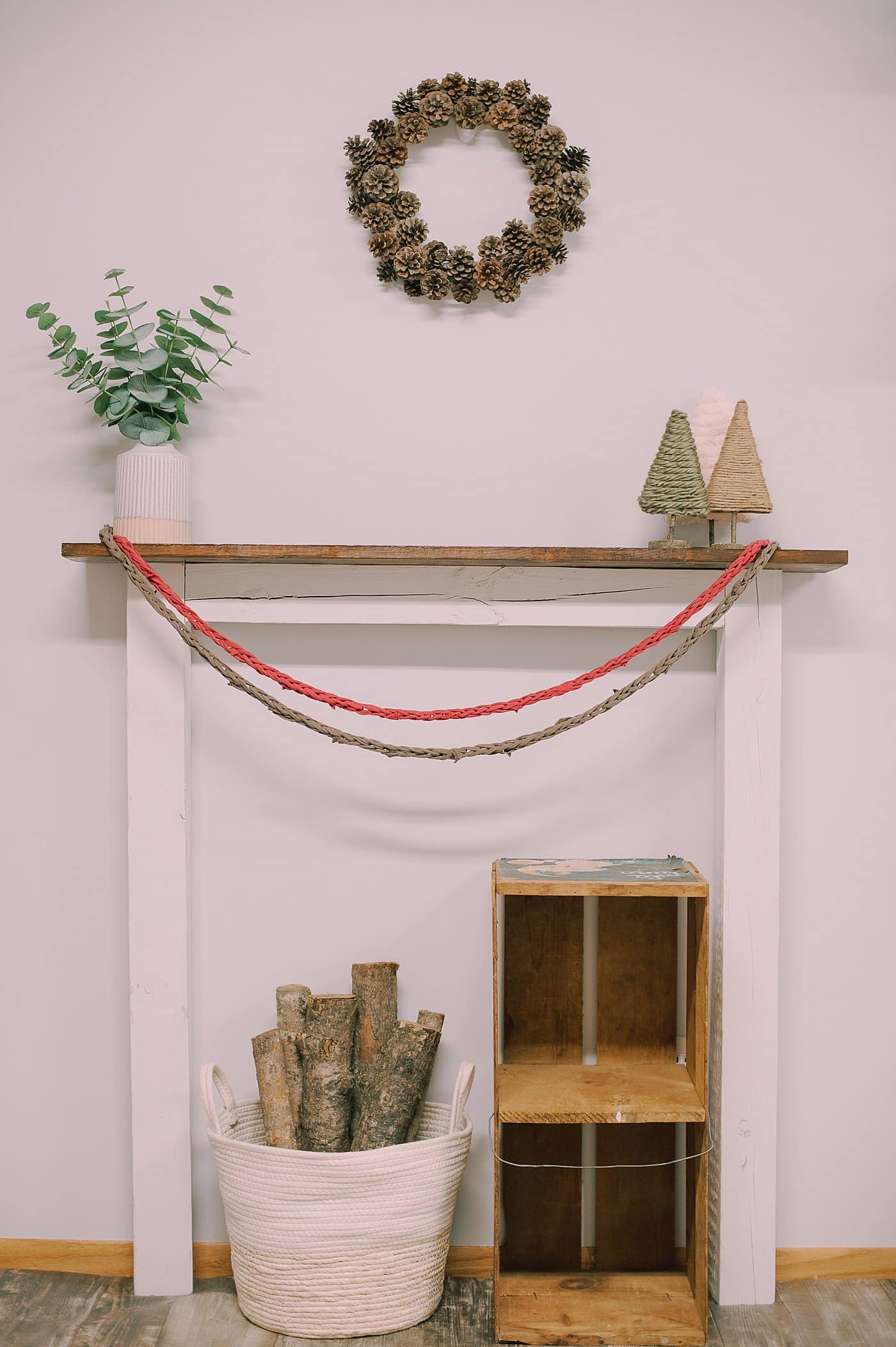 Two finger knit garlands having on a wood mantel.