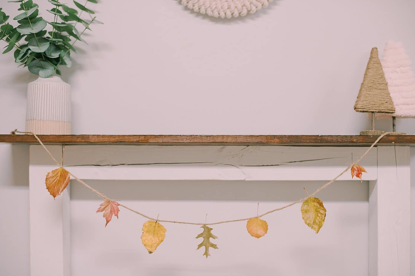 Beeswax-dipped leaf garland on a mantel.