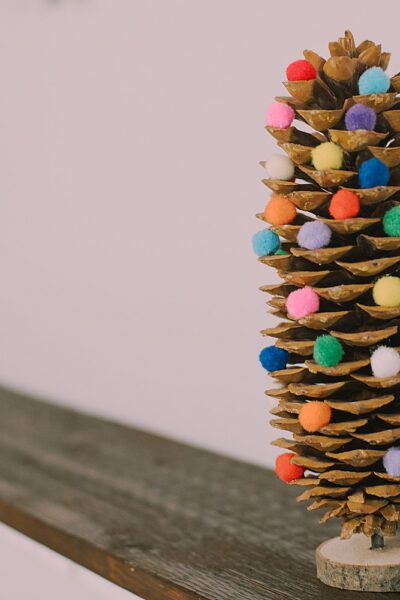 Unleash your holiday creativity! Learn how to craft a stunning DIY Giant Pinecone Christmas Tree adorned with pompoms. Get ready to spread festive cheer!