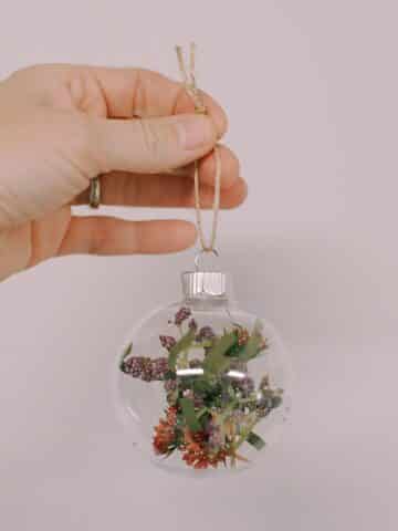 Create your own Faux Flower Glass Ball Ornament with our simple guide. Add a personal touch to your holiday decor this season!