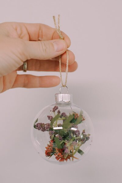 Create your own Faux Flower Glass Ball Ornament with our simple guide. Add a personal touch to your holiday decor this season!