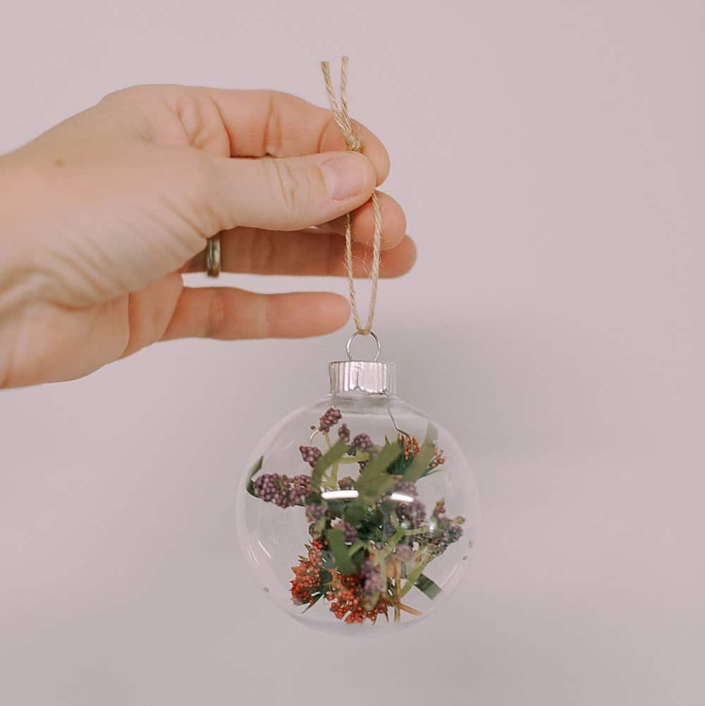 Create your own Faux Flower Glass Ball Ornament with our simple guide. Add a personal touch to your holiday decor this season!