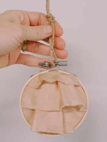 Learn how to make a keepsake memory ornament using special fabric from a loved one, and putting it inside an embroidery hoop.
