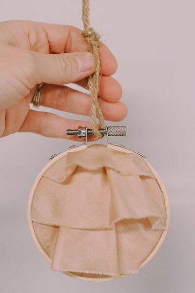 Learn how to make a keepsake memory ornament using special fabric from a loved one, and putting it inside an embroidery hoop.