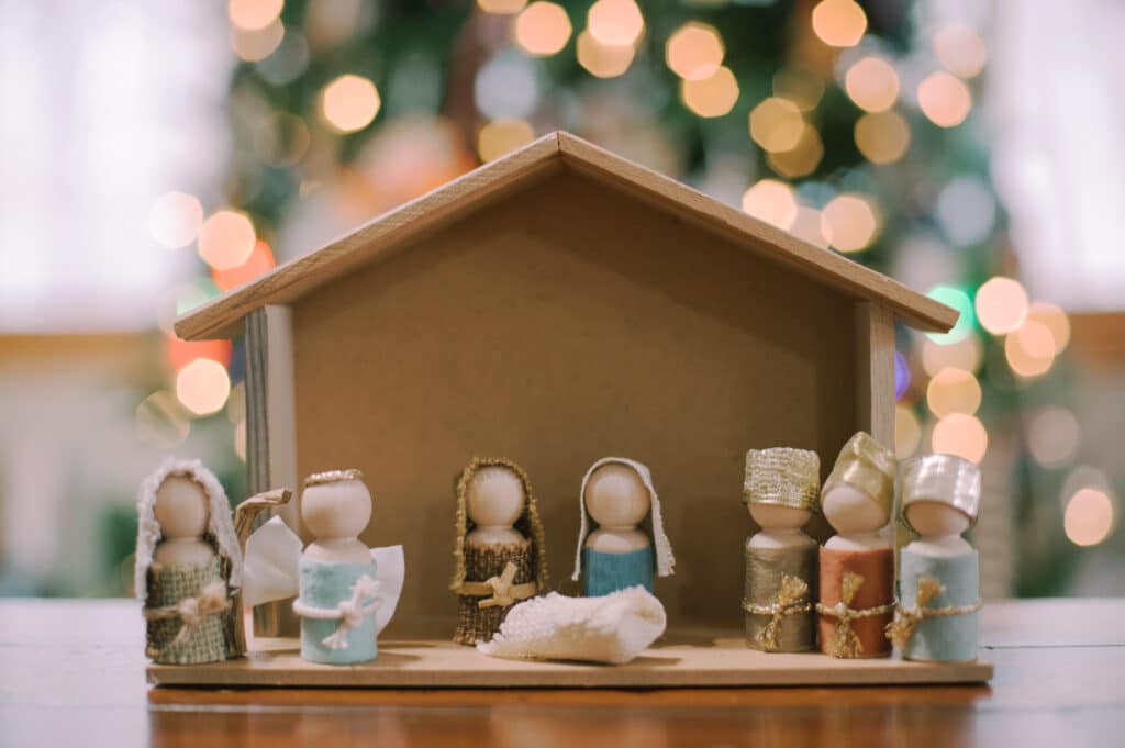 Handmade wooden nativity set, made with wooden peg dolls and fabric and ribbon scraps for clothing.
