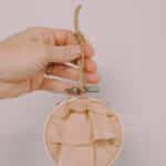 How to make a keepsake memory ornament with fabric and an embroidery hoop.